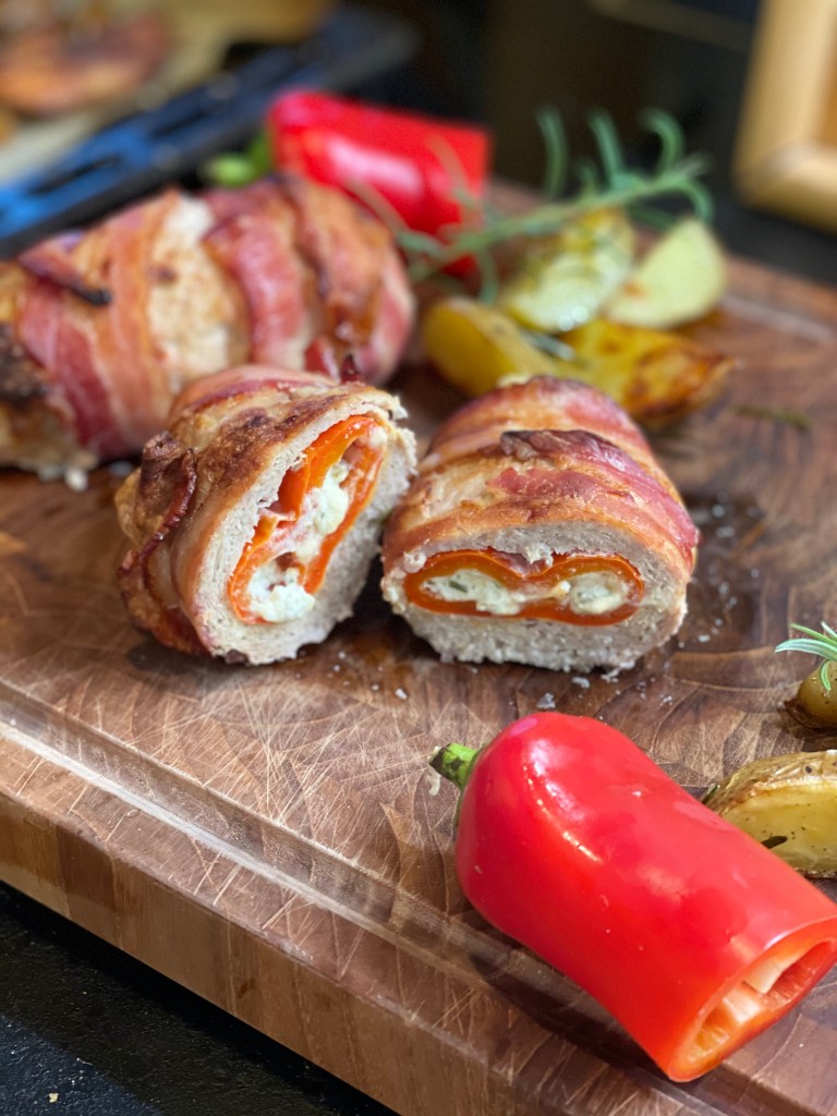 An armadillo egg. It is cut in the middle to show its gooey, cheesy centre.